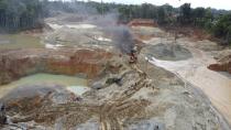 The National Police destroy an illegal gold mining operation with soldiers standing guard as part of the Armed Forces' "Operation Guamuez III" in Magui Payan, Colombia, Tuesday, April 20, 2021. Illegal gold mining is common in Colombia, especially wildcat mines in poverty-stricken areas dominated by criminal gangs with little state presence. (AP Photo/Fernando Vergara)