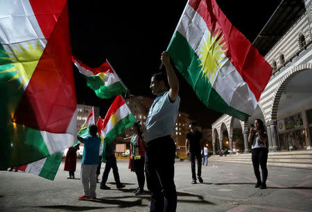 People wave Kurdish flags in Diyarbakir, Turkey September 25, 2017. REUTERS/Sertac Kayar