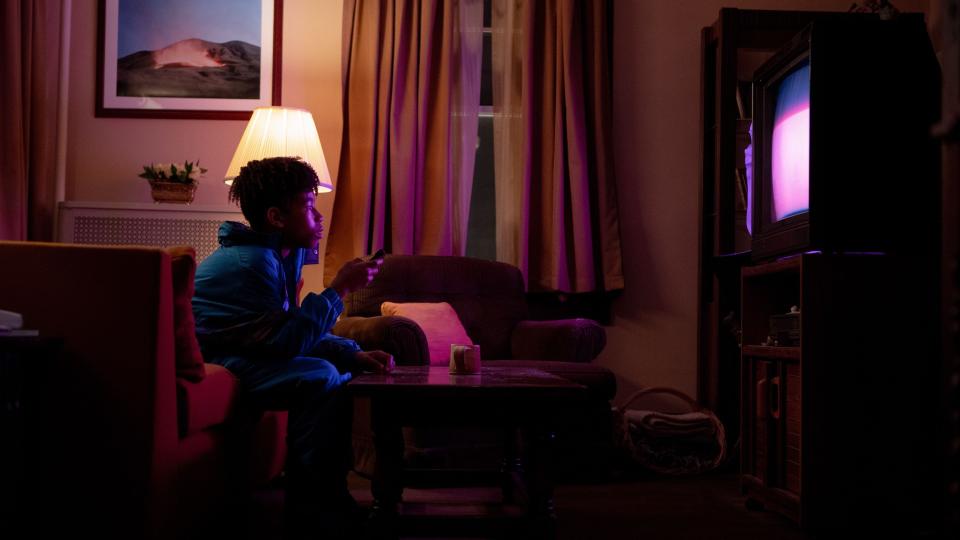 Ian Foreman watches TV in a still in I Saw the TV Glow.