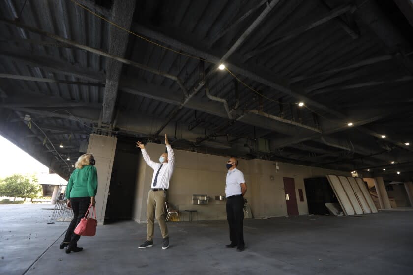 LYNWOOD, CA - OCTOBER 28, 2021 - - Maria G. Lopez, President of Lynwood Unified School District Board of Education, from left, Gregory Fromm, Chief Business Official for Lynwood Unified School District and Gustavo Gonzalez, Director of Maintenance, Operation and Transportation for Lynwood Unified School District, assess the damage at the site of a building collapse at Lynwood High School - Imperial in Lywood on October 28, 2021. The collapse happened in June 2020 when students were not allowed on campus during the height of the pandemic. "If this had happened when students were here, there would have been multiple deaths," said Gregory Fromm, Chief Business Official for Lynwood Unified School District. Officials have been assessing the impact of the construction failure on the local educational community. Lynwood High School, a relatively new flagship campus in the Lynwood Unified School District, was condemned as unsafe to use after further investigation proved some parts of the school structurally unsound. (Genaro Molina / Los Angeles Times)