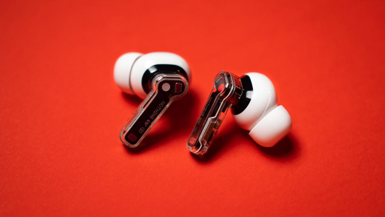  Nothing Ear (2) earbuds review on red background. 