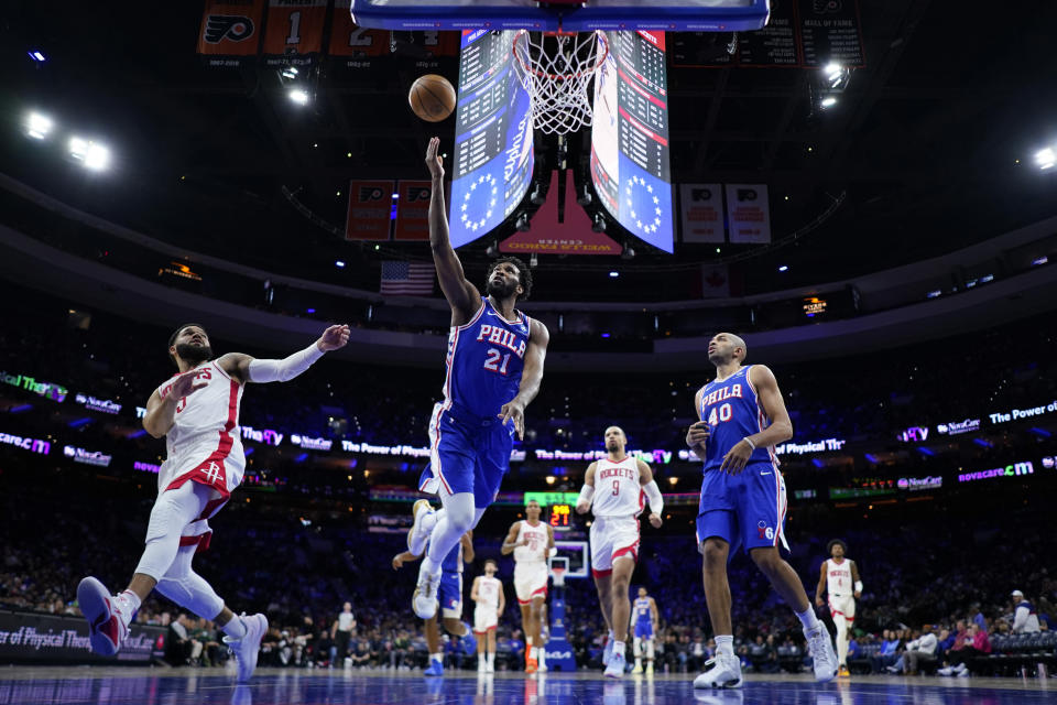 Philadelphia 76ers' Joel Embiid (21) goes up for a shot against Houston Rockets' Fred VanVleet (5) during the second half of an NBA basketball game, Monday, Jan. 15, 2024, in Philadelphia. (AP Photo/Matt Slocum)