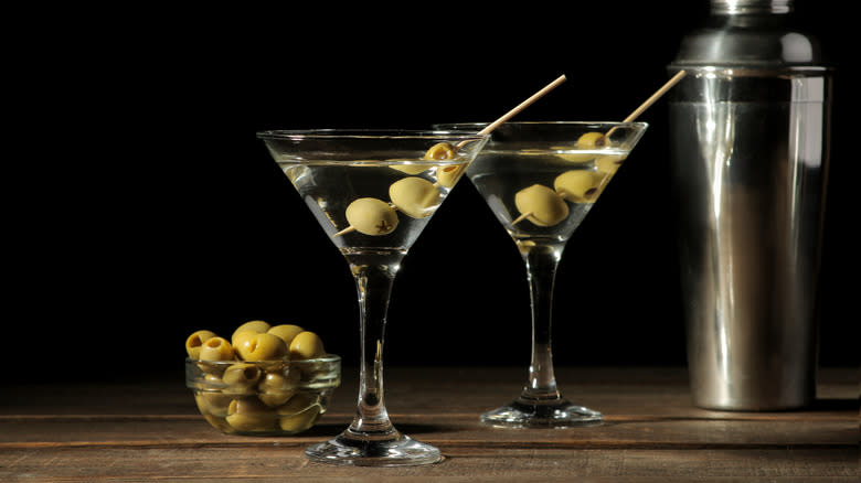 Two martini glasses with olives