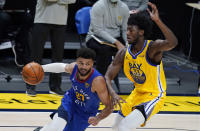 Denver Nuggets guard Jamal Murray, left, drives past Golden State Warriors center James Wiseman in the first half of an NBA basketball game Thursday, Jan. 14, 2021, in Denver. (AP Photo/David Zalubowski)