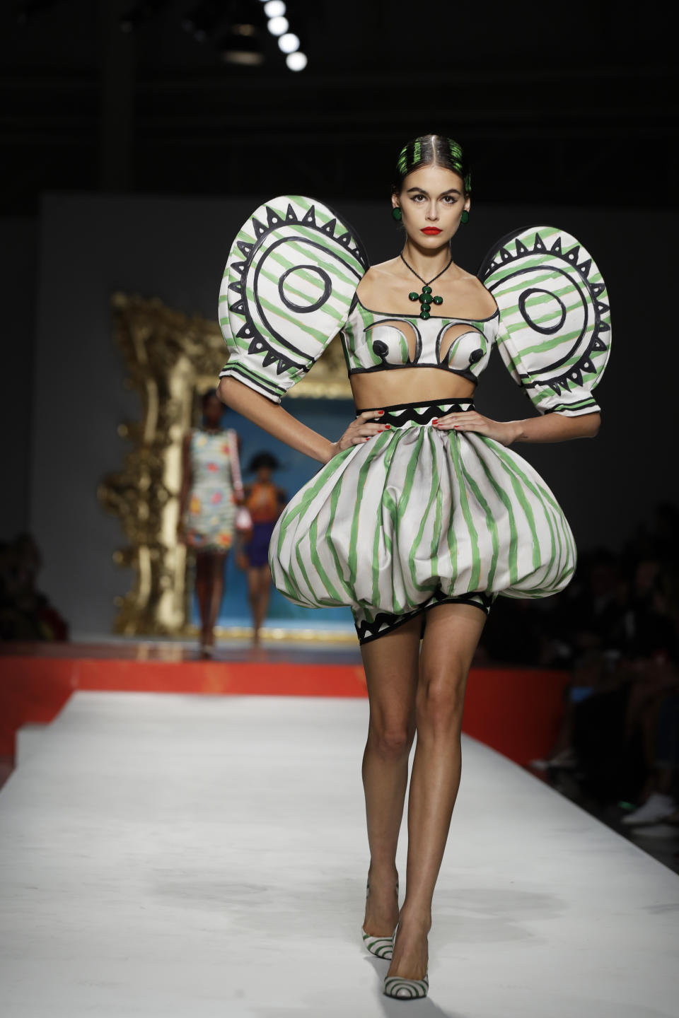 Model Kaia Gerber wears a creation as part of the Moschino Spring-Summer 2020 collection, unveiled during the fashion week, in Milan, Italy, Thursday, Sept. 19, 2019. (AP Photo/Luca Bruno)