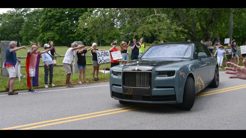 Protestors gathered on Saturday outside 51 Putnam Ave. in Cotuit as Florida Gov. Ron DeSantis held a fundraiser.