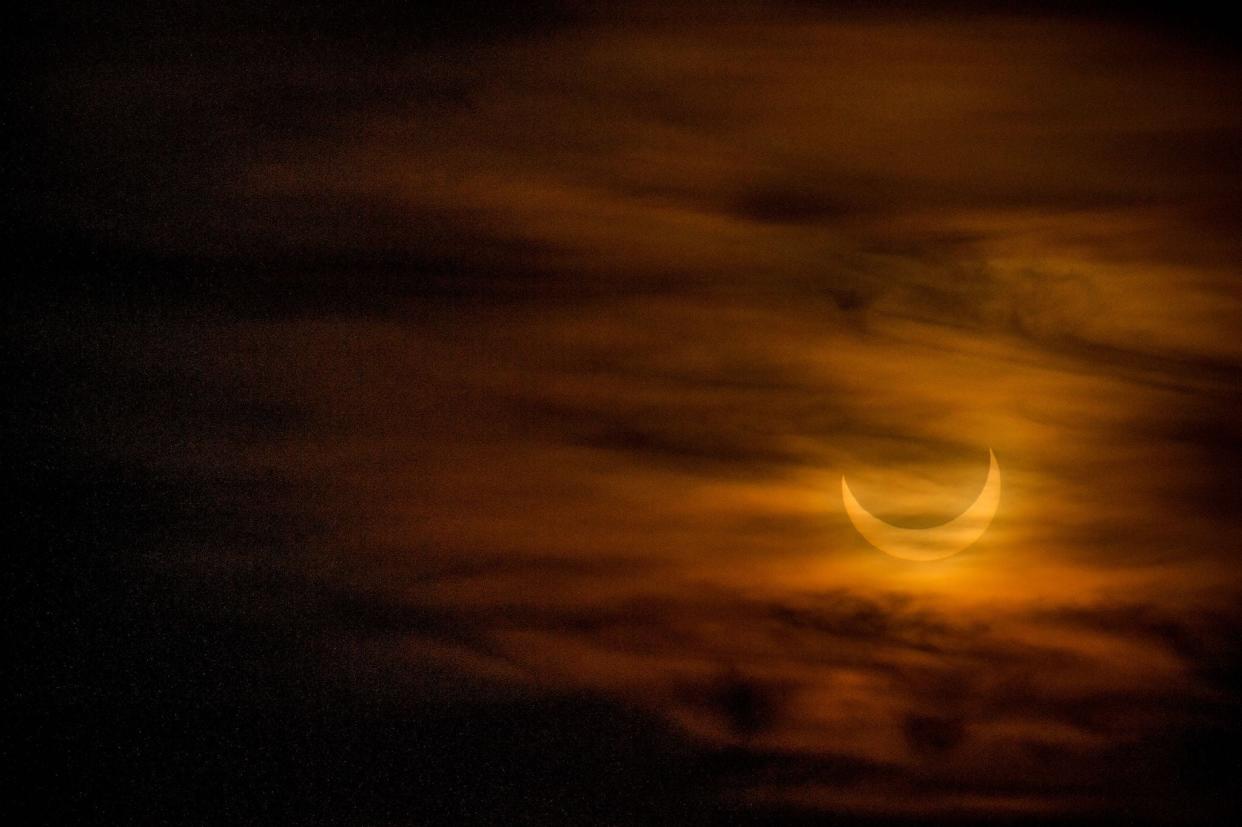 A annular eclipse is seen as the sun rises over Scituate, Massachusetts (AFP via Getty Images)