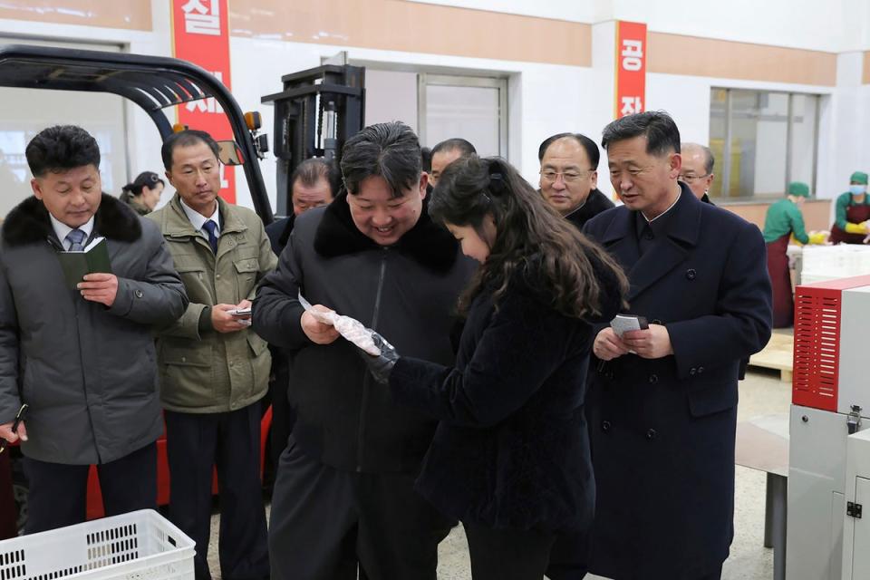 In this photo provided on Monday, 8 January 2024, by the North Korean government, North Korean leader Kim Jong-un, centre, with his daughter visits a newly-built chicken farm in Hwangju County of North Hwanghae Province on 7 January 2024 (KCNA via KNS)