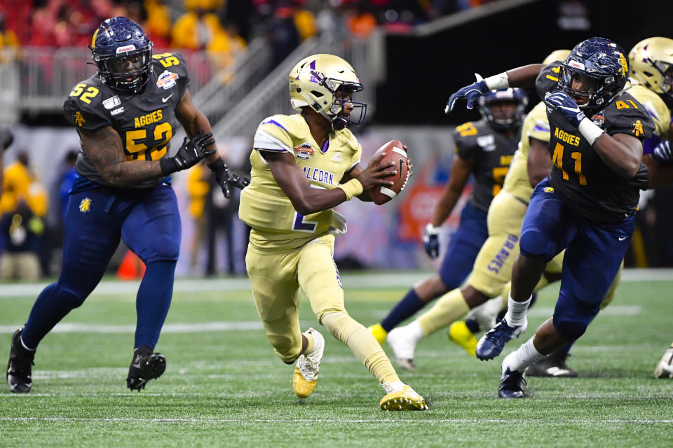 Alcorn State quarterback Felix Harper tries to evade the defense of North Carolina A&T linebacker Julian Monell (53) and defensive lineman Leon Smalls (41) during the second half of the Celebration Bowl NCAA college football game, Saturday, Dec. 21, 2019, in Atlanta. North Carolina A&T won 64-44. (John Amis/Atlanta Journal-Constitution via AP)