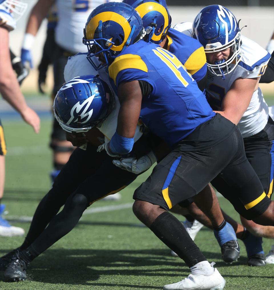 Angelo State University linebacker Daron Allman, 14, makes a tackle during an NCAA Division II second-round playoff game against Nebraska-Kearney at LeGrand Stadium at 1st Community Credit Union Field on Saturday, Nov. 27, 2021.