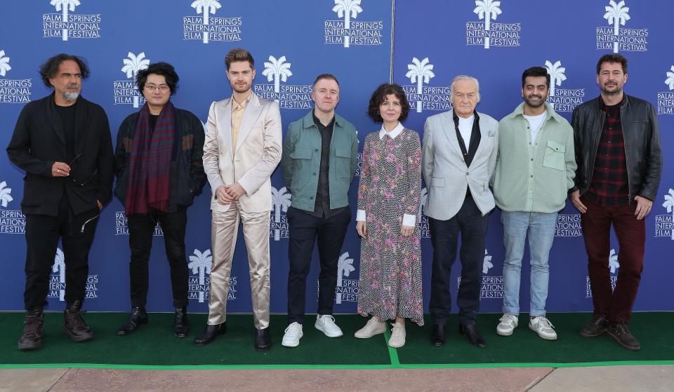 From left, Alejandro Inarritu, Davy Chou, Lukas Dhont, Colm Bairead, Marie Kruetzer, Jerzy Skolimowski, Saim Sadiq and Santiago Mitre take a photo during a panel discussion at the Camelot Theatre in Palm Springs, Calif., Jan. 11, 2023.