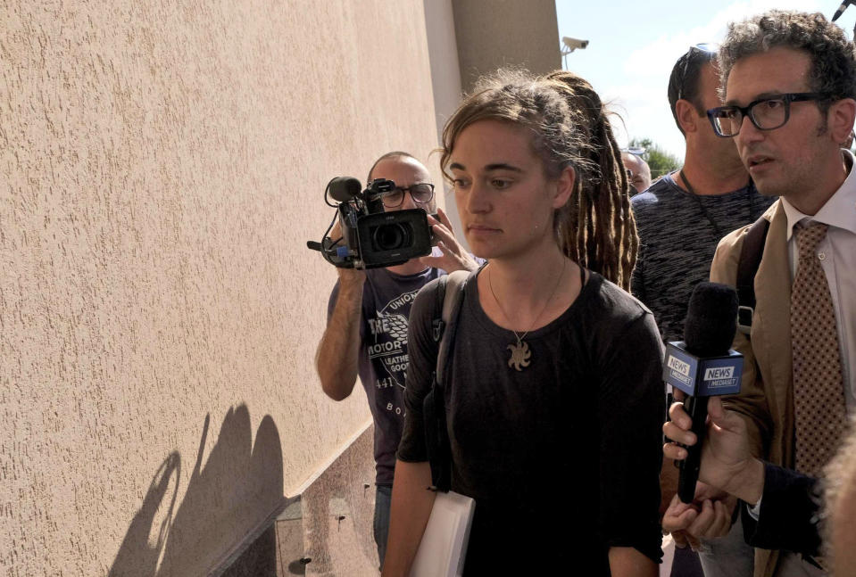 Sea-Watch3 German captain Carola Rackete is accompanied by her lawyer Leonardo Marino, right, as she arrives for questioning in court in the southern Sicilian town of Agrigento, Italy, Thursday, July 18, 2019. Rackete, who forced a government block docking at an Italian port after rescuing migrants, faces questioning by Italian prosecutors over allegedly aiding illegal immigration. (Pasquale Claudio Montana Lampo/ANSA via AP)