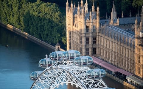 Mo Farah does the 'Mobot' against the backdrop of Westminster - Credit: PA