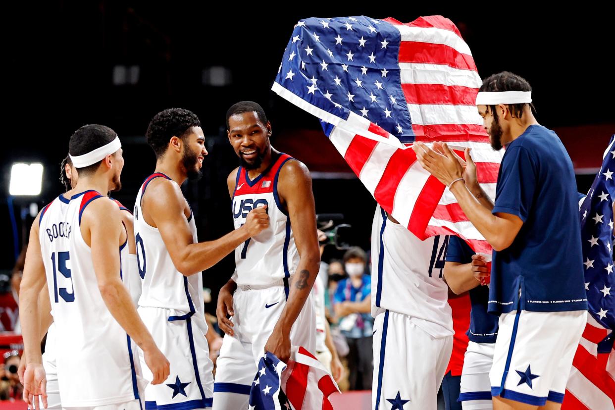 The United States celebrates winning the gold medal against France in men's basketball during the Tokyo 2020 Olympic Summer Games at Saitama Super Arena.