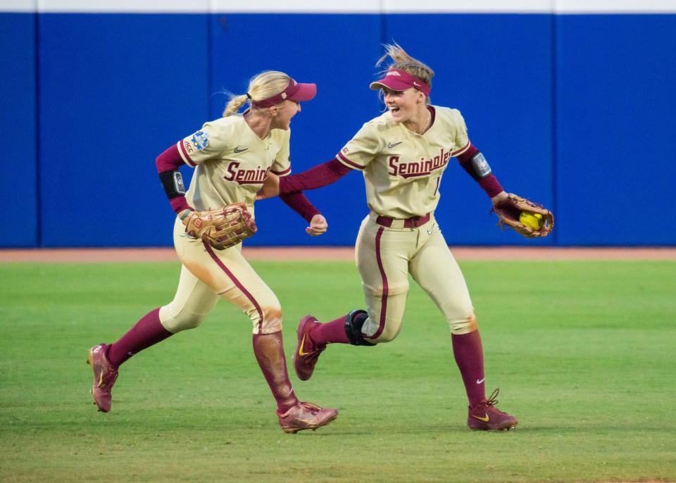 Florida State shortstop Josie Muffley (10) and outfielder Kaley Mudge (6) run off the field after the final out against Tennessee during the Women's College World Series at the USA Softball Hall of Fame Stadium.