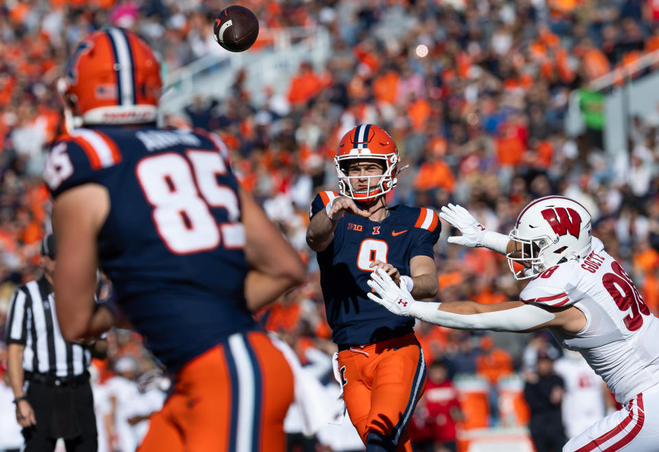 Luke Altmyer #9 of the Illinois Fighting Illini throws the ball to Tanner Arkin #85 of the Illinois Fighting Illini for a touchdown against C.J. Goetz #98 of the Wisconsin Badgers during the first half at Memorial Stadium on Oct. 21, 2023 in Champaign, Illinois. Michael Hickey/Getty Images