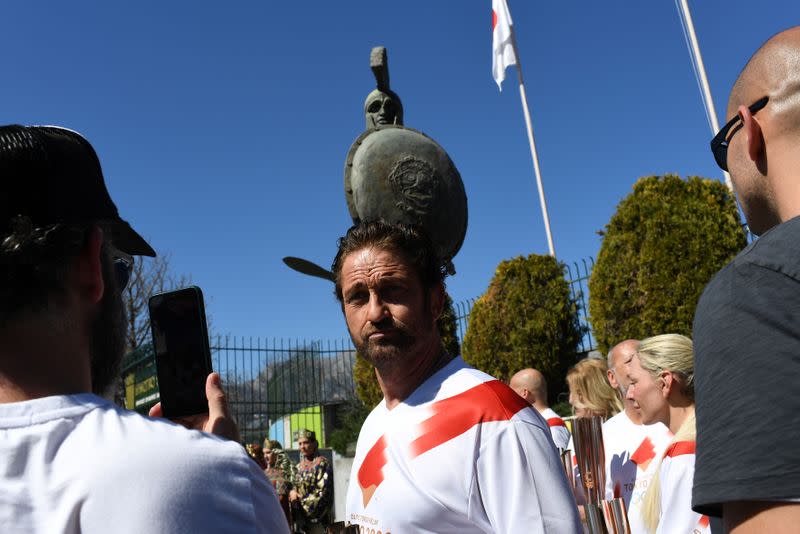 US actor Gerard Butler takes part in the Olympic flame torch relay for the Tokyo 2020 Summer Olympics