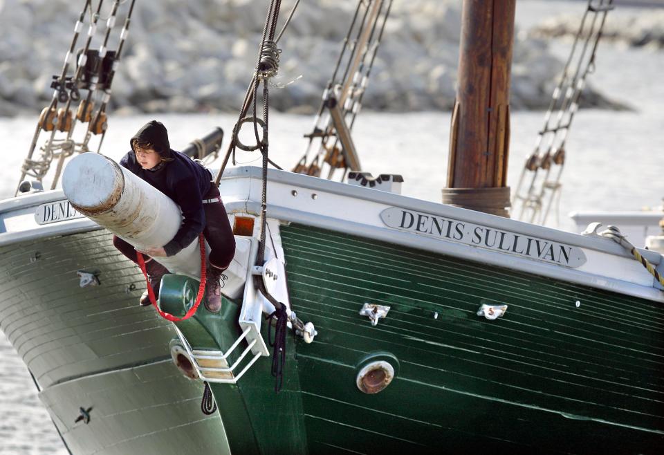 Ruby Johnstone, a member of the crew, sands the bow spirit of  the tall ship Denis Sullivan on April 5, 2013. Repairs for the next month include replacing the center mast and other maintenance before the ship begins its summer sailing season.