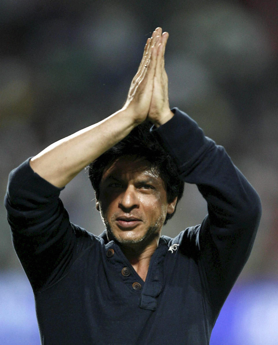 Kolkata Knight Riders' co owner and Bollywood star Shah Rukh Khan, greets the crowd as he celebrates his team's victory in their Indian Premier League (IPL) cricket playoff match against Delhi Daredevils in Pune, India, Tuesday, May 22, 2012. (AP Photo) INDIA OUT