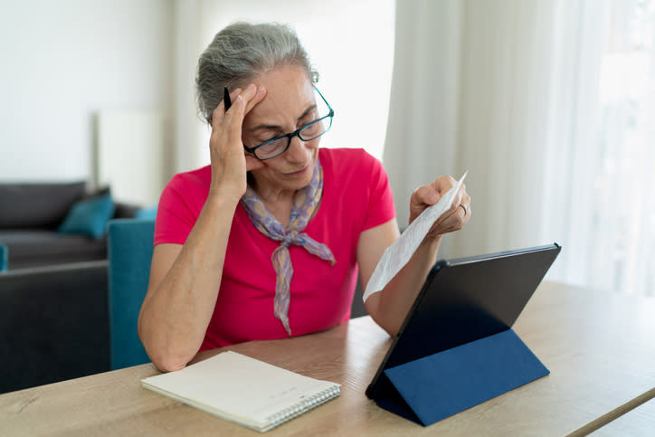 An older woman examines her tax-advantaged accounts