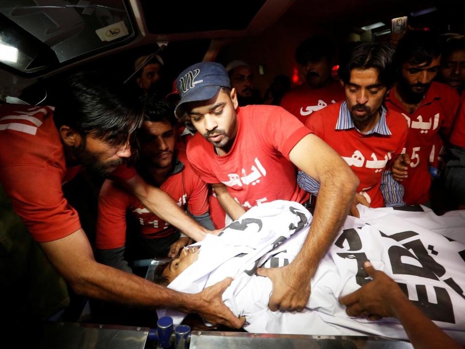 ‘It is our job to check if anyone is alive, not to ask any questions’ (Akhtar Soomro/Reuters)