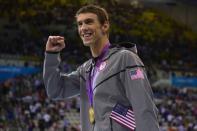 US swimmer Michael Phelps poses with the gold medal after winning the men's 4x100 medley relay final during the swimming event at the London 2012 Olympic Games on August 4, 2012 in London