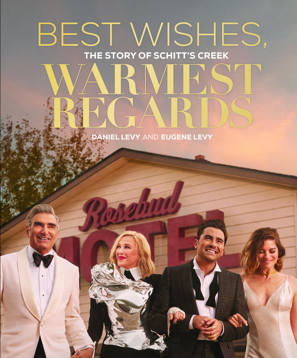 This photo shows the book cover for “Best Wishes, Warmest Regards: The Story of Schitt’s Creek” by Daniel Levy and Eugene Levy. (Black Dog & Leventhal via AP)