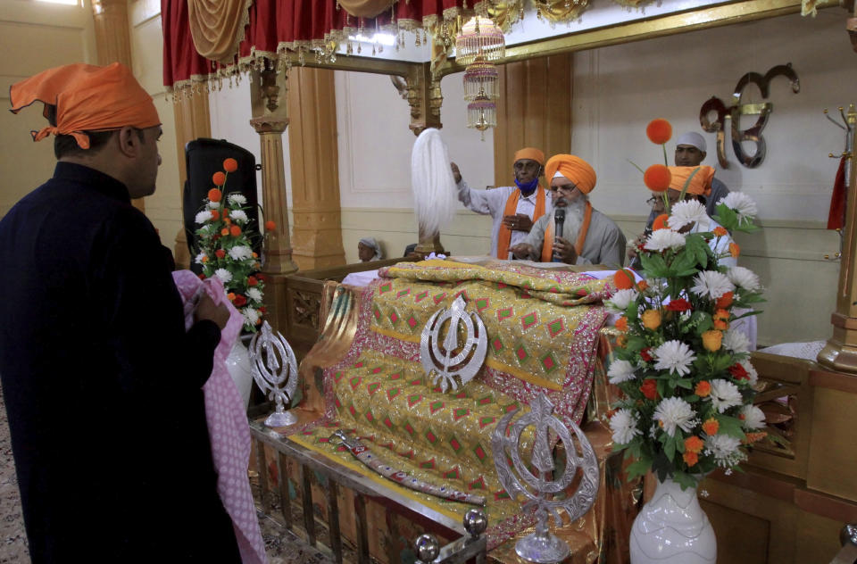 People of the Sikh community take part in worship at the Gurudawara Sri Guru Singh Sabha temple in Quetta, Pakistan, Thursday, July 23, 2020. The 200-year-old Sikh temple that served as a school for Muslim girls for seven decades was returned to the Sikh community in the city of Quetta, enabling them to worship there for the first time in 73 years, officials said Thursday. (AP Photo/Arshad Butt)