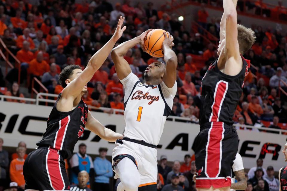 Oklahoma State Cowboys guard Bryce Thompson (1) puts up a shot between Eastern Washington Eagles forward Angelo Allegri (13), left,  and forward Dane Erikstrup (32) during a college basketball game between the Oklahoma State Cowboys (OSU) and the Eastern Washington Eagles in the second round of the NIT at Gallagher-Iba Arena in Stillwater, Okla., Sunday, March 19, 2023. 