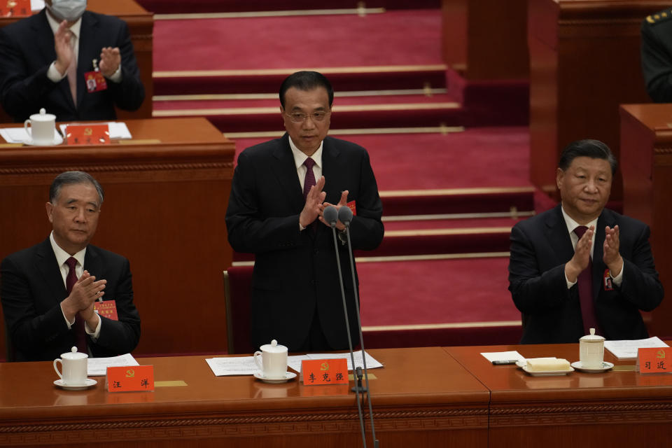 Chinese Premier Li Keqiang speaks near Chinese President Xi Jinping during the opening ceremony of the 20th National Congress of China's ruling Communist Party held at the Great Hall of the People in Beijing, China, Sunday, Oct. 16, 2022. China on Sunday opens a twice-a-decade party conference at which leader Xi Jinping is expected to receive a third five-year term that breaks with recent precedent and establishes himself as arguably the most powerful Chinese politician since Mao Zedong. (AP Photo/Mark Schiefelbein)