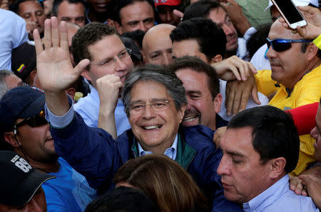 Guillermo Lasso, presidential candidate from the CREO party, greets supporters outside the electoral council (CNE) headquarters, in Quito, Ecuador, February 21, 2017. REUTERS/Henry Romero