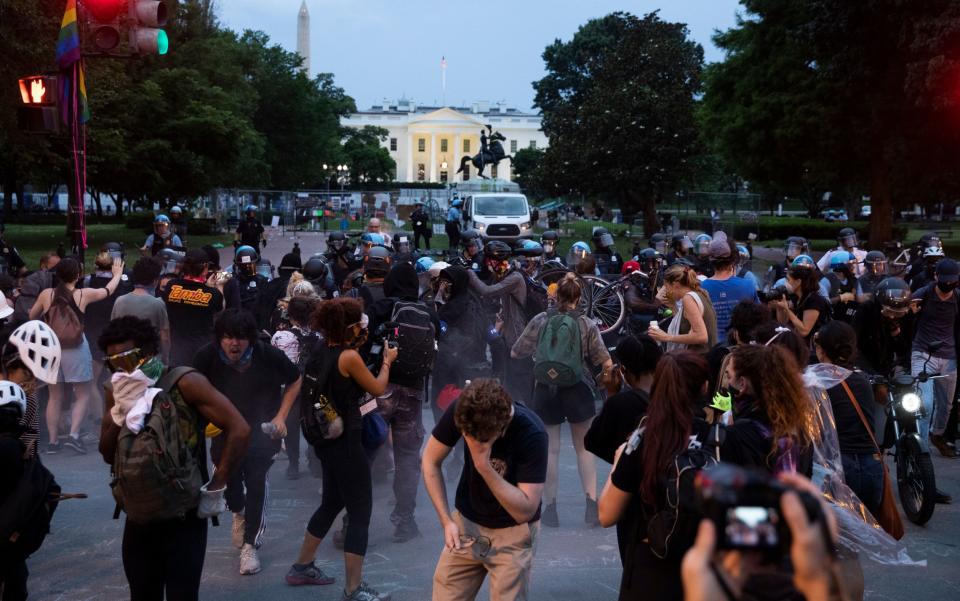 People react as police use pepper spray to clear out Lafayette Park across the street from the White House - MICHAEL REYNOLDS/EPA-EFE/Shutterstock