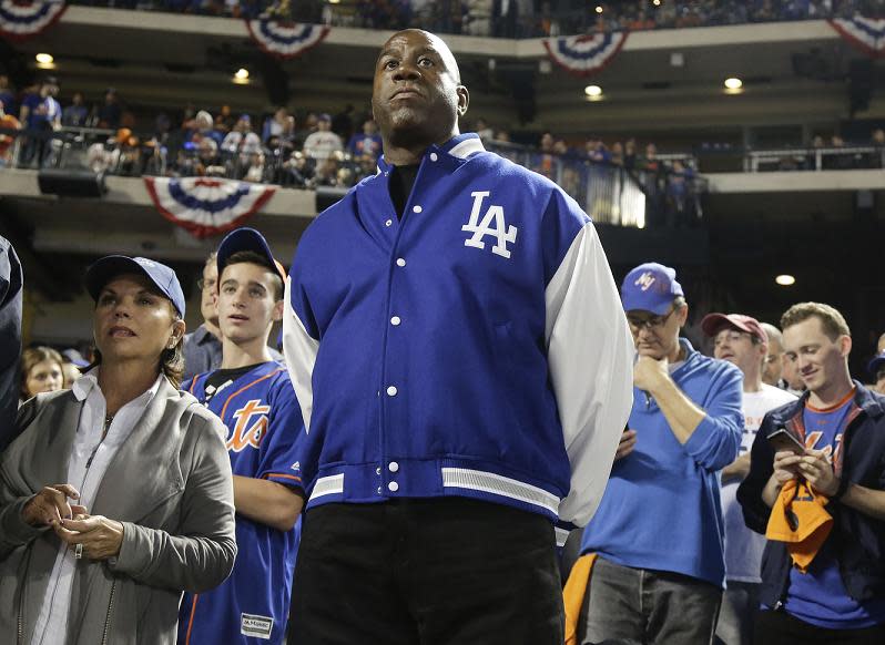 Dodgers co-owner Magic Johnson, seen here in 2015, is balancing his time between the Dodgers and Lakers. (AP)