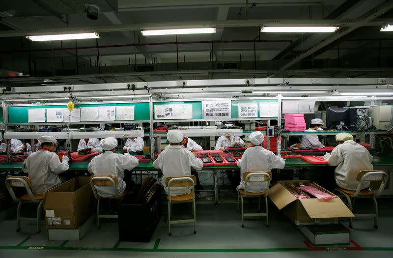 FILE PHOTO: Workers are seen inside a Foxconn factory in the township of Longhua in the southern Guangdong province
