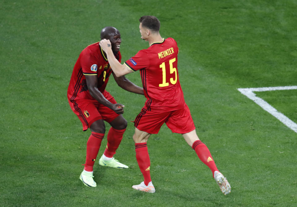 Belgium's Thomas Meunier, right, celebrates with Belgium's Romelu Lukaku after scoring his sides second goal during the Euro 2020 soccer championship group B match between Russia and Belgium at the Saint Petersburg stadium in St. Petersburg, Russia, Saturday, June 12, 2021. (Anton Vaganov/Pool via AP)