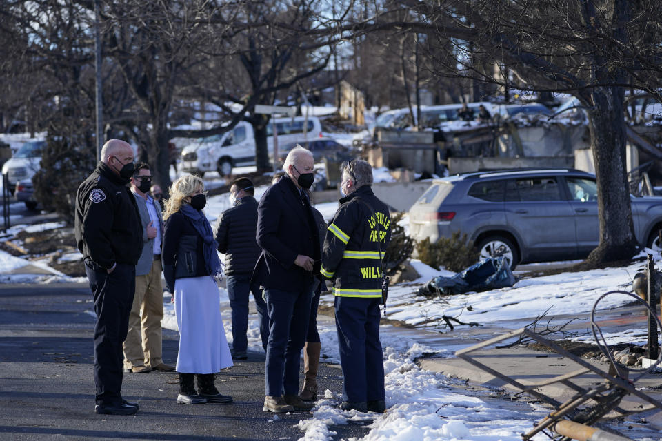 President Joe Biden and first lady Jill Biden tour a neighborhood in Louisville, Colo., Friday, Jan. 7, 2022, that was impacted by the recent wildfire. (AP Photo/Susan Walsh)