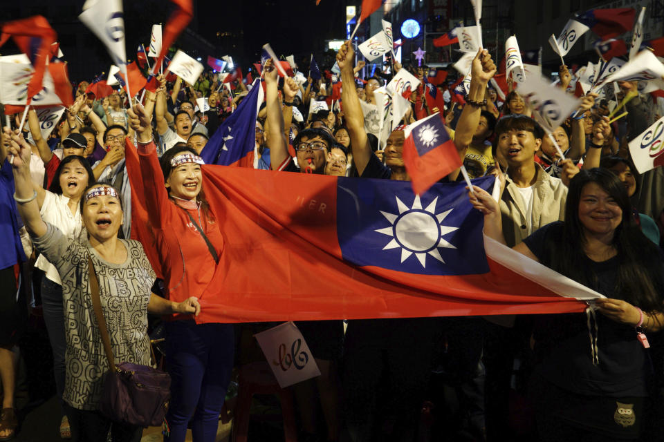 Supporters of the opposition Nationalist Party cheer in Kaohsiung, Taiwan, Saturday, Nov. 24, 2018. Taiwan's ruling party suffered a major defeat Saturday in local elections seen as a referendum on the administration of the island's independence-leaning president amid growing economic and political pressure from China. (AP Photo)