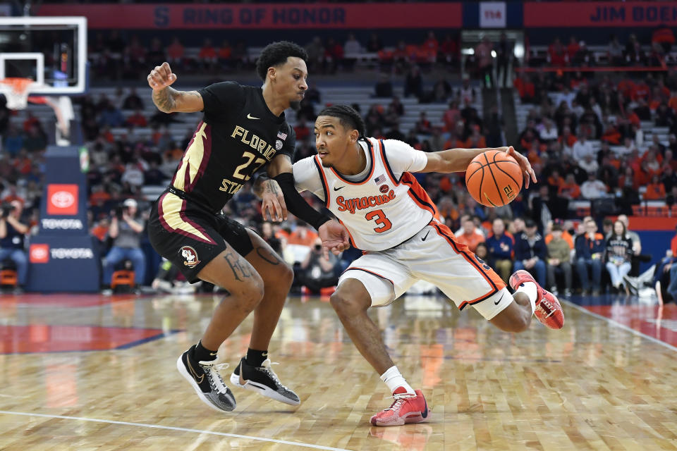 Syracuse guard Judah Mintz, right, is defended by Florida State guard Primo Spears during the second half of an NCAA college basketball game in Syracuse, N.Y., Tuesday, Jan. 23, 2024. (AP Photo/Adrian Kraus)