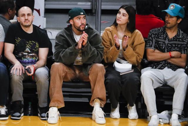 Bad Bunny sits courtside for the game between the Charlotte