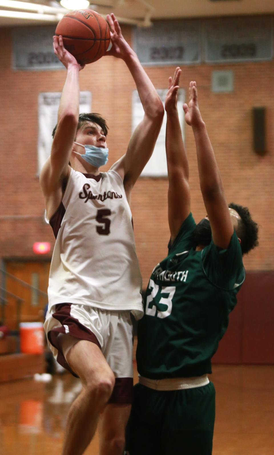 Ethan Clark shoots over John Emile for two Friday in Bishop Stang's 63-49 win over Dartmouth at the John C. O'Brien Gymnasium.