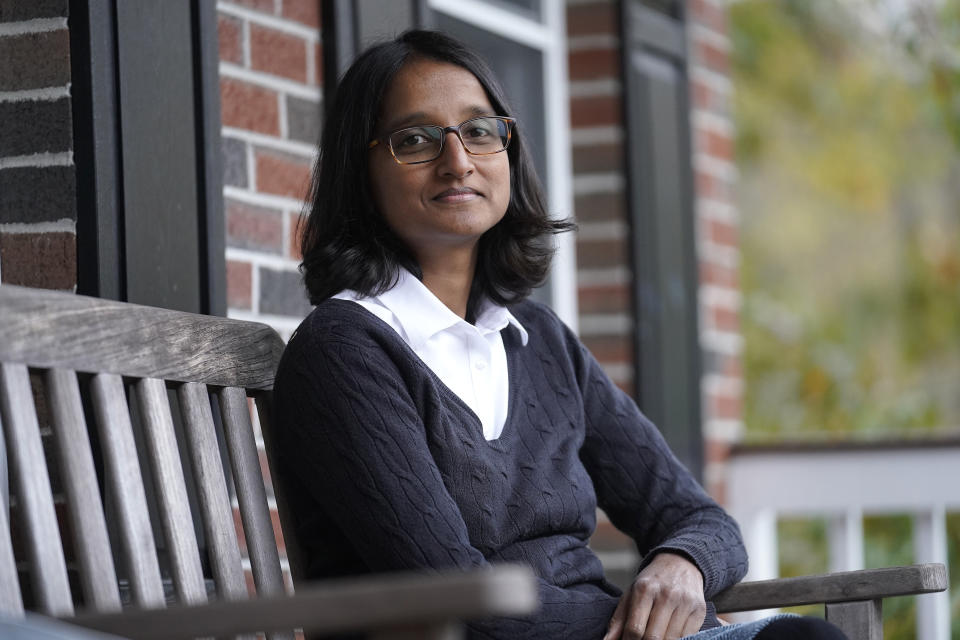 Erika Constantine, of North Attleboro, Mass., poses for a portrait on the front porch of her home, Thursday, Oct. 29, 2020, in North Attleboro. Canadian-born Constantine spoke up during her naturalization ceremony after Federal immigration officials incorrectly told new U.S. citizens in Massachusetts that they couldn't vote in this year's general election because the state's registration deadline had passed before they took their citizenship oaths. (AP Photo/Steven Senne)