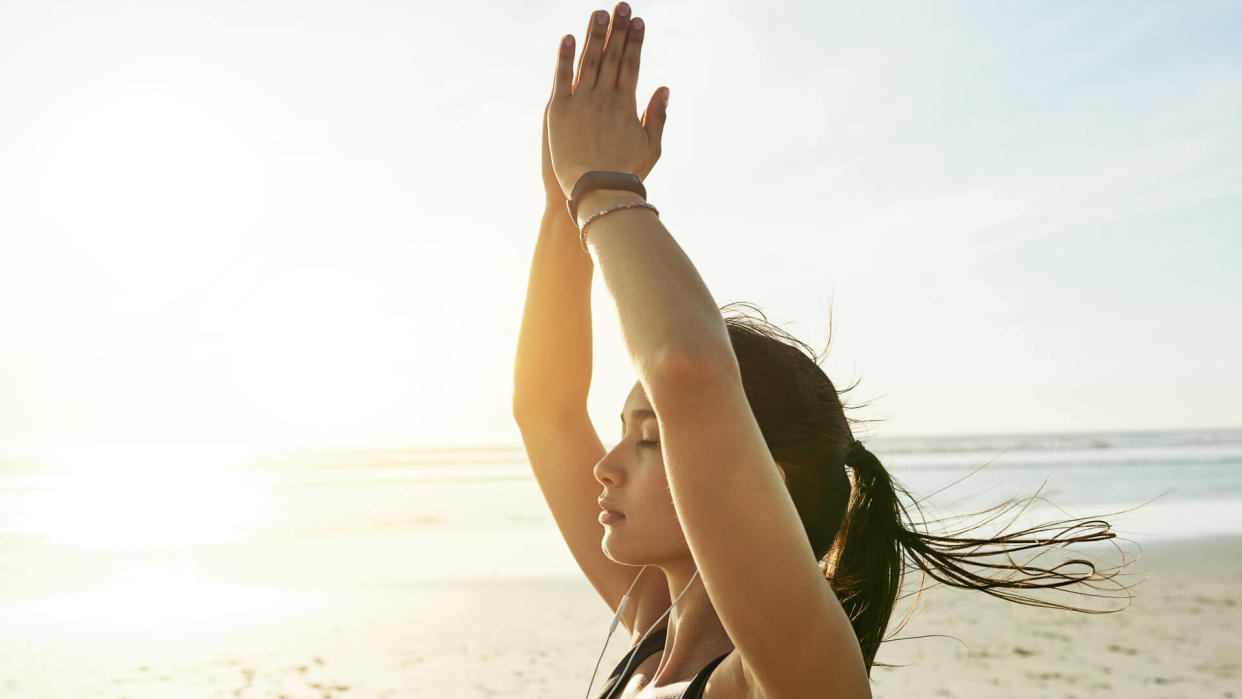 Cropped shot of an attractive and athletic young woman working out on the beach.