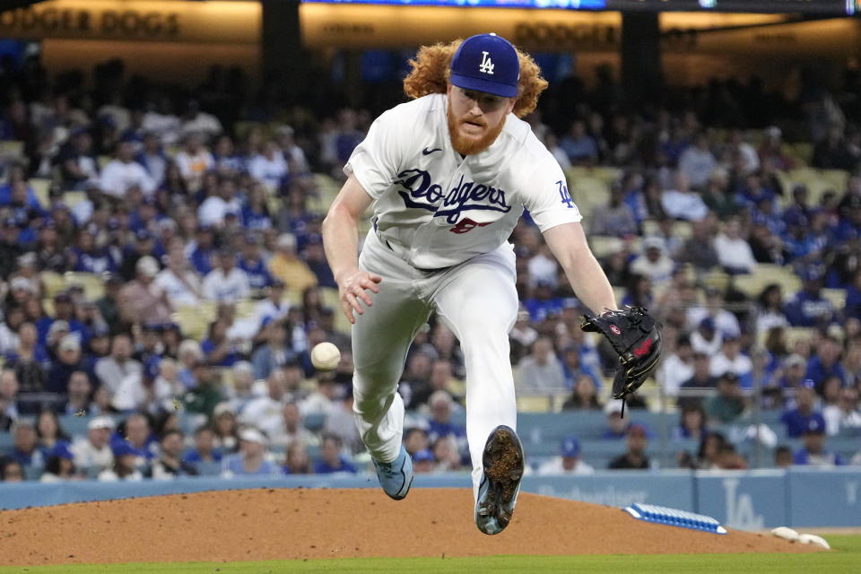 Los Angeles Dodgers starting pitcher Dustin May fields a ball hit by San Diego Padres' Juan Soto before forcing him out at first during the second inning of a baseball game Friday, May 12, 2023, in Los Angeles. (AP Photo/Mark J. Terrill)