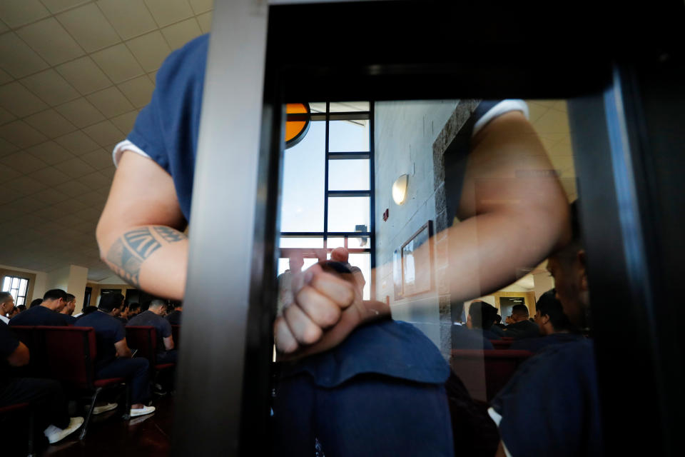 Detainees listen to a Pentacostal preacher who is a fellow detainee in a packed chapel inside the Winn Correctional Center in Winnfield, La., Thursday, Sept. 26, 2019. (AP Photo/Gerald Herbert)