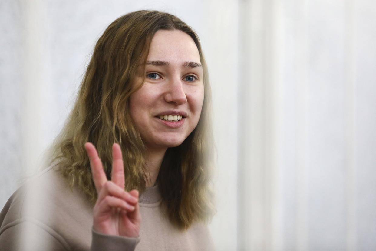 Journalist Daria Chultsova gestures inside a defendants' cage in a court room in Minsk, Belarus, Thursday, Feb. 18. 