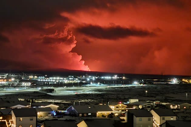 Smoke billows from the eruption as seen from the village of Hafnarfjordur on Monday.