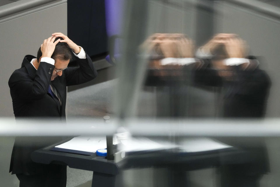 Israeli President Isaac Herzog adjusts a skullcap as he delivers a speech at the German parliament Bundestag at the Reichstag building in Berlin, Germany, Tuesday, Sept. 6, 2022. (AP Photo/Markus Schreiber)