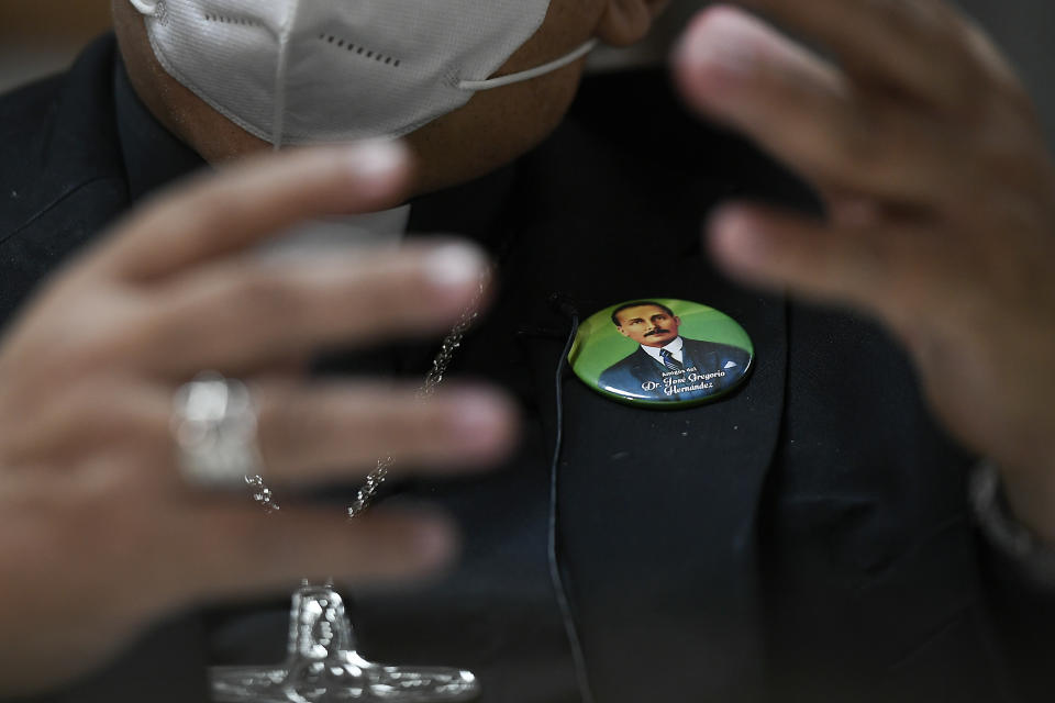 Monsignor Tulio Ramirez wears a pin of the late Dr. Jose Gregorio Hernandez during an interview about Hernandez's beatification in Caracas, Venezuela, Tuesday, April 27, 2021. Known as the "doctor of the poor," Hernandez is set to be beatified by the Catholic church, a step towards sainthood, on April 30th. (AP Photo/Matias Delacroix)