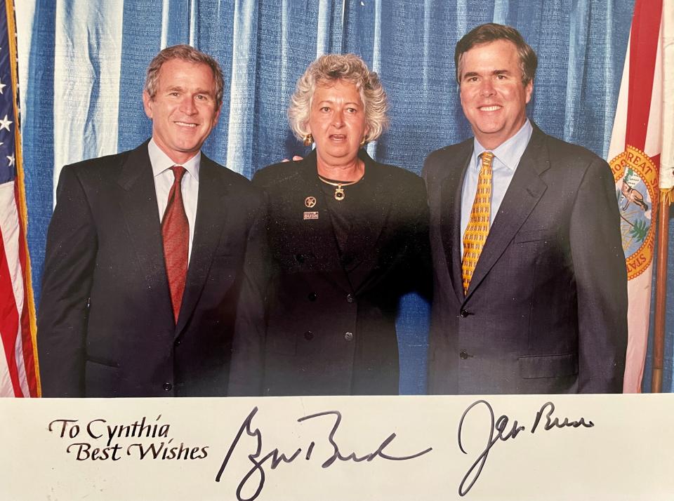 President George W. Bush and Florida Governor Jeb Bush autographed this photo with Cynthia Handley. Her husband, Jim, said she was caught off-guard while the brothers were joking with each other.