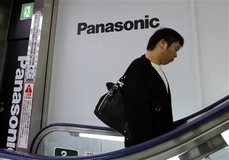 A man walks past Panasonic Corp's logos at an electronics store in Tokyo October 31, 2013. REUTERS/Toru Hanai